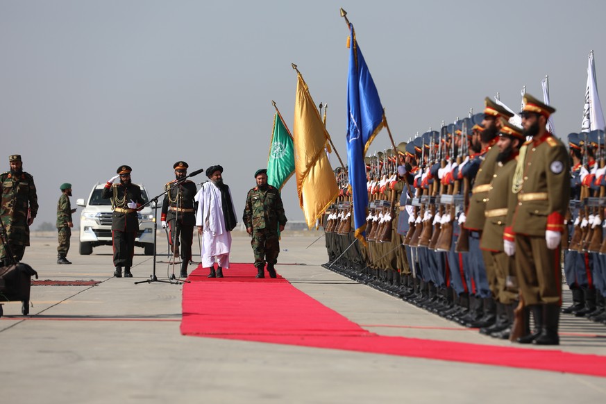 epa11548934 Deputy Prime Minister for Economic Affairs Mullah Abdul Ghani Baradar (C) attends a military parade to celebrate the third anniversary of the Taliban government takeover, in Bagram, Afghan ...
