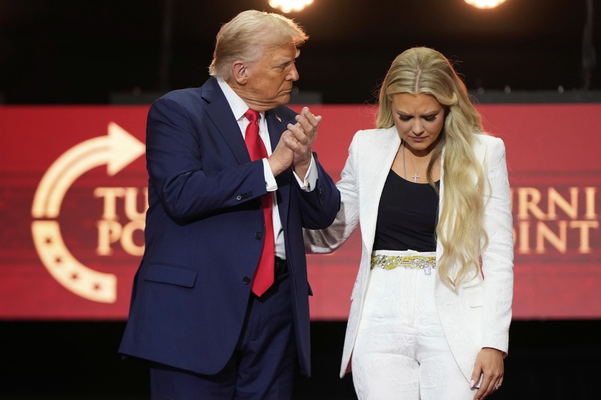 President Donald Trump, left, stands with Erika Kirk at the conclusion of a memorial for her husband, conservative activist Charlie Kirk, Sunday, Sept. 21, 2025, at State Farm Stadium in Glendale, Ari ...