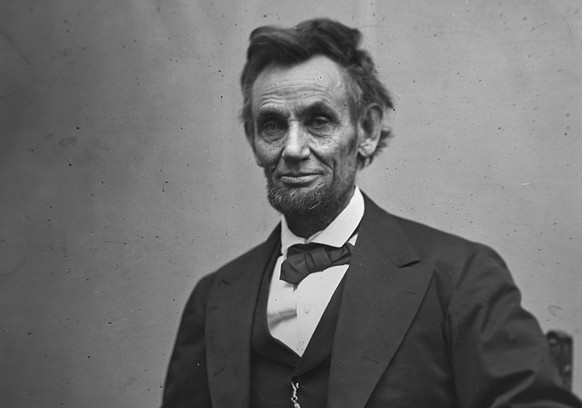 In this photo provided by the Library of Congress, Abraham Lincoln is pictured in a three-quarter length portrait, seated and holding his spectacles and a pencil. This image was taken by photographer  ...