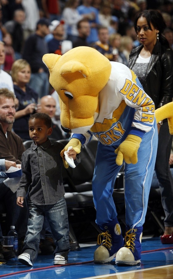 Denver Nuggets mascot Rocky the Mountain Lion, front right, guides the son of Nuggets forward Carmelo Anthony, Kiyan Anthony, front left, to his seat as the child&#039;s mother, former video disc jock ...