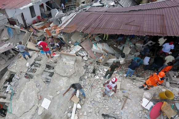 epa13159883 An aerial photograph showing civilians searching through the rubble of a building destroyed after a powerful earthquake in Quibdo, Colombia, 10 August 2026. A 7.4-magnitude earthquake shoo ...