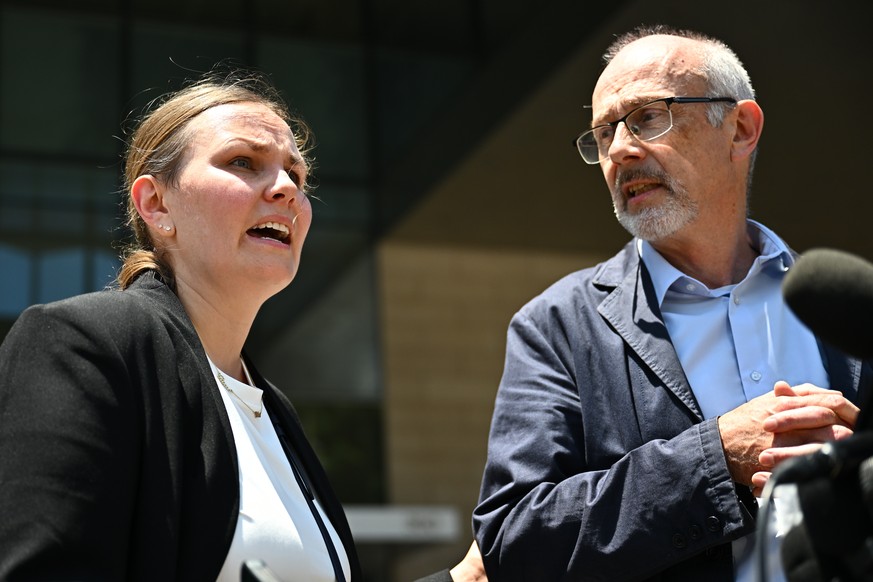 From left, Leah Rinderknecht, sister of Jonathan Rinderknecht speaks as her father Joel Rinderknecht, listens, outside federal court after a federal judge declared a mistrial in the arson case against ...