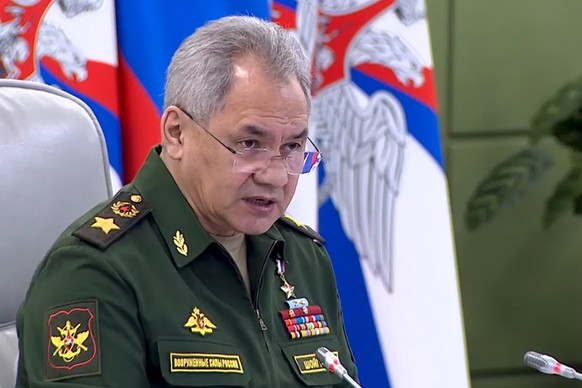 In this handout photo taken from video released by Russian Defense Ministry Press Service, Russian Defense Minister Sergei Shoigu speaks during a meeting with high level officers in Moscow, Russia, on ...