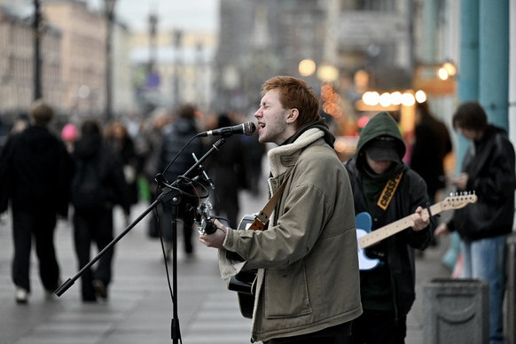Arseny, a 21-year-old street musician, performs in central Saint Petersburg on October 27, 2025.