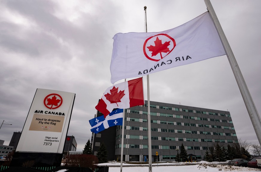 Flags fly at half mast outside Air Canada head offices in Saint Laurent, Que., on Monday, March 23, 2026. (Christinne Muschi/The Canadian Press via AP)
Canada NY LaGuardia Crash