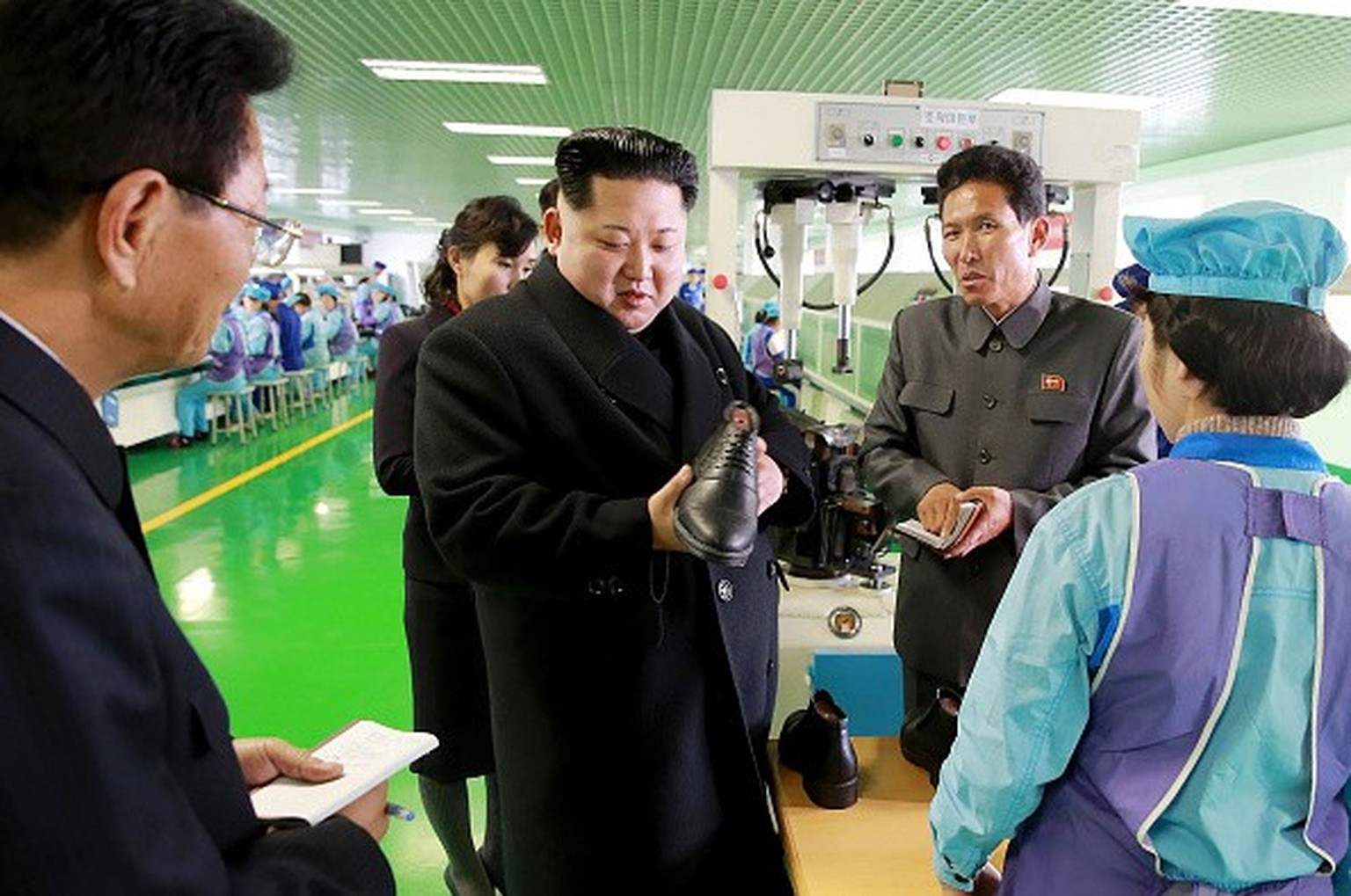 This undated photo released by North Korea&amp;#039;s official Korean Central News Agency (KCNA) on December 9, 2016 shows North Korean leader Kim Jong-Un (C) at the Wonsan Shoes Factory in Kangwon Pr ...