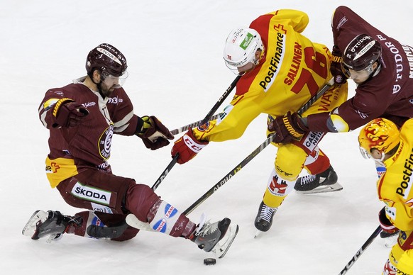 Biel&#039;s forward Jere Sallinen, centre, vies for the puck with Geneve-Servette&#039;s defender Arnaud Jacquemet, left, and Geneve-Servette&#039;s forward Marco Miranda, right, during the third leg  ...