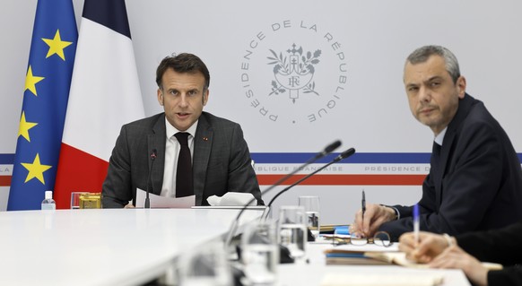epa11274894 France&#039;s President Emmanuel Macron (L) and Secretary-General of the Elysee Palace Alexis Kohler (R) take part in a videoconference with German Chancellor Olaf Scholz (unseen) at the E ...