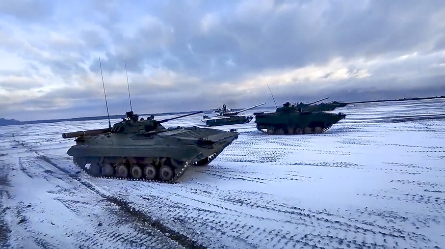 In this photo taken from video and released by the Russian Defense Ministry Press Service on Wednesday, Feb. 2, 2022, Russian and Belarusian tanks drive during joint military drills at Brestsky firing ...