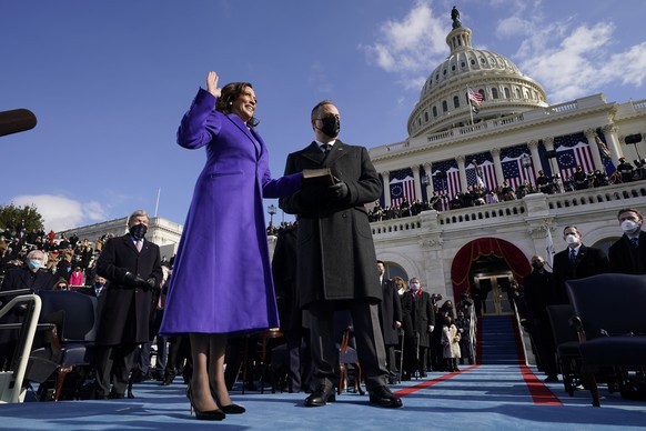 FILE - Kamala Harris is sworn in as Vice President by Supreme Court Justice Sonia Sotomayor as her husband Doug Emhoff holds the Bible during the 59th Presidential Inauguration at the U.S. Capitol in  ...