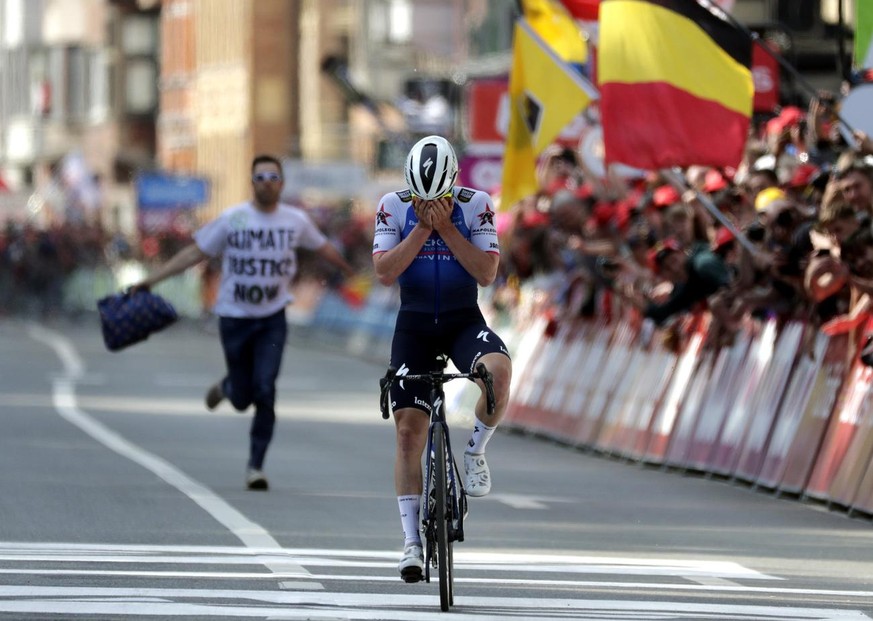 epa09906878 Belgian rider Remco Evenepoel of the Quick-Step Alpha Vinyl Team reacts while crossing the finish line to win the Liege-Bastogne-Liege one day cycling race over 257.2km in Liege, Belgium,  ...