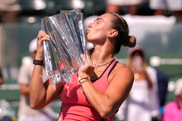 Aryna Sabalenka, of Belarus, kisses the winner's trophy after defeating Elena Rybakina, of Kazakhstan, to win the BNP Paribas Open tennis tournament Sunday, March 15, 2026, in Indian Wells, Calif ...