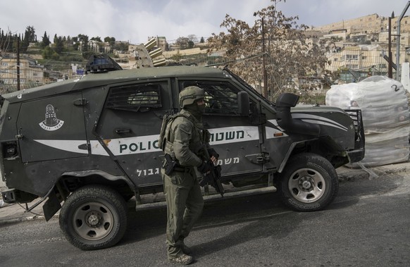 An Israeli policeman secures a shooting attack site in east Jerusalem, Saturday, Jan. 28, 2023. A Palestinian gunman opened fire in east Jerusalem on Saturday, wounding at least two people less than a ...