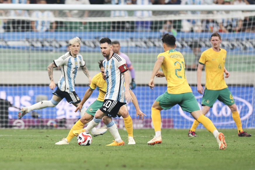 BEIJING, CHINA - JUNE 15: Lionel Messi of Argentina and Denis Genreau of Australia compete for the ball during the international friendly match between Argentina and Australia at Workers Stadium on Ju ...