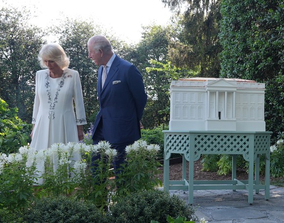 President Donald Trump and first lady Melania Trump along with Britain's King Charles III and Queen Camilla pose for a photo by White House bee hive at the White House, Monday, April 27, 2026, in ...