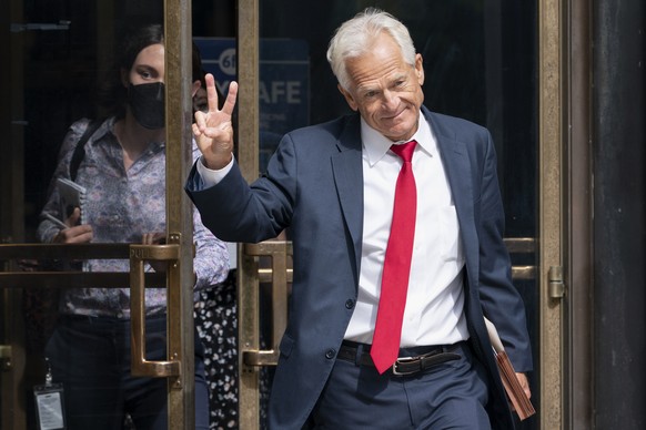Former Trump White House official Peter Navarro gestures, Friday, June 3, 2022, as he leaves federal court in Washington. Navarro was indicted Friday on contempt charges after defying a subpoena from  ...