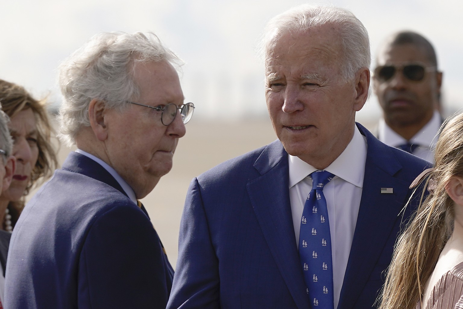 Senate Minority Leader Mitch McConnell of Ky., looks to President Joe Biden after Biden arrived at Cincinnati/Northern Kentucky International Airport in Hebron, Ky., Wednesday, Jan. 4, 2023. (AP Photo ...