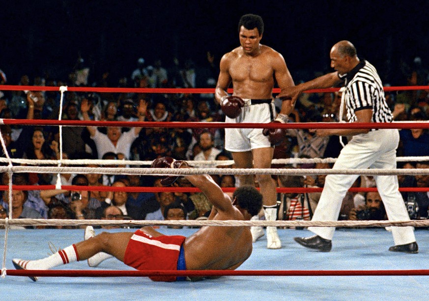 FILE - Referee Zack Clayton, right, steps in after challenger Muhammad Ali, second from right, knocked down defending heavyweight champion George Foreman, bottom, in the eighth round of their champion ...