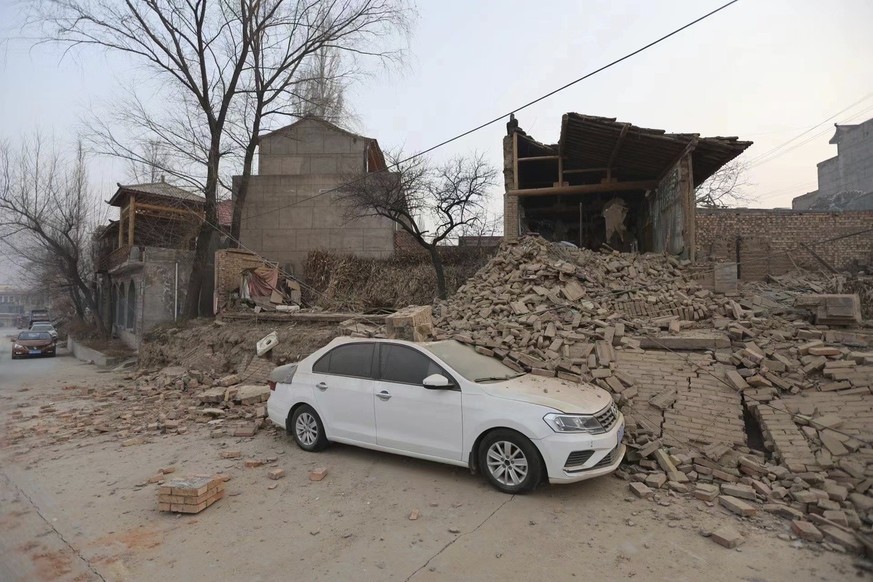 A vehicle is partially covered by a collapsed building in the aftermath of an earthquake in Dahejia village of Jishishan county in northwestern China&#039;s Gansu province Tuesday, Dec. 19, 2023. An o ...