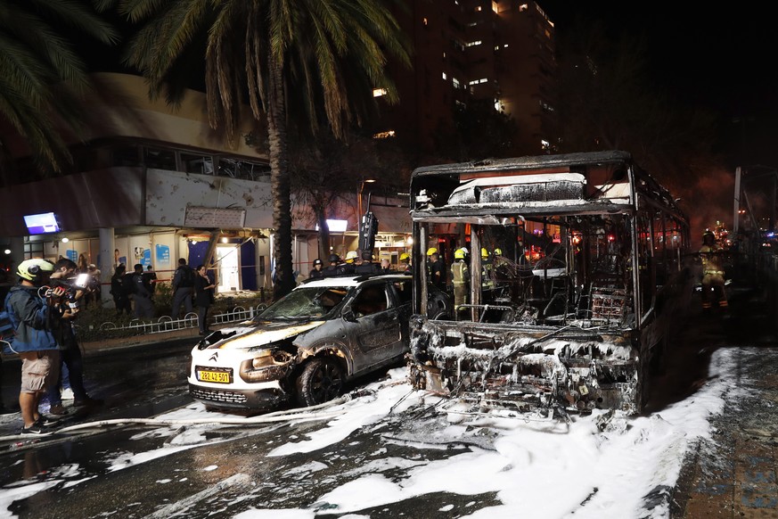 epa09192264 View of damaged vehicles after a rockets attack, at the city of Holon near Tel Aviv, 11 May 2021. At least one woman was killed after 130 rockets fired by Hamas from Gaza strip fell on Tel ...