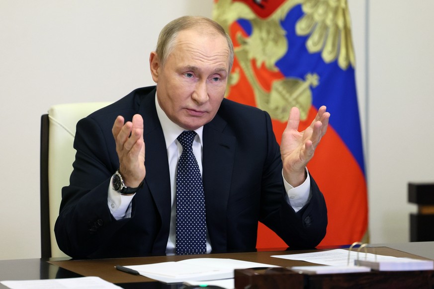 Russian President Vladimir Putin gestures during a meeting with the winners and finalists of the School Teacher of the Year national contest via videoconference at the Novo-Ogaryovo residence outside  ...