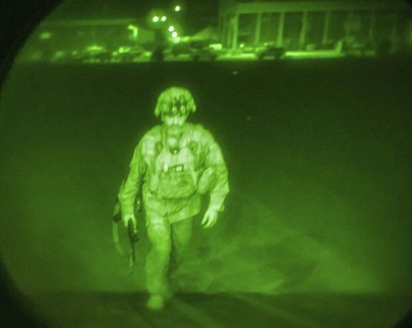 In this image made through a night vision scope and provided by U.S. Central Command, Maj. Gen. Chris Donahue, commander of the U.S. Army 82nd Airborne Division, XVIII Airborne Corps, boards a C-17 ca ...