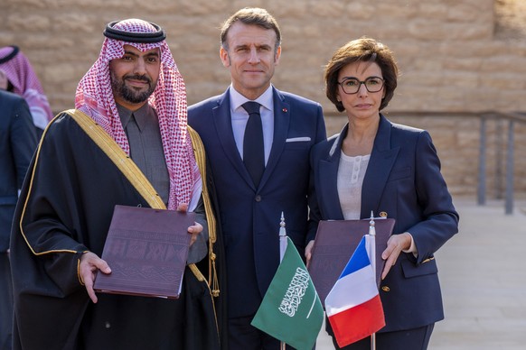 In this photo provided by the Saudi Ministry of Media, French President Emmanuel Macron, center, Prince Bader bin Abdullah bin Farhan Al Saud, left, and his French counterpart, Rachida Dati, pose afte ...