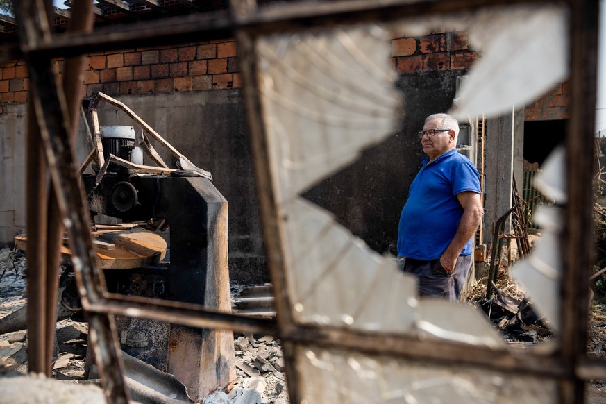 epa11614318 Jose Santos, 72, inspects his carpentry workshop destroyed by the fires in Gondomar, Portugal, 19 September 2024. At least seven people died and 40 were injured in the fires that have been ...