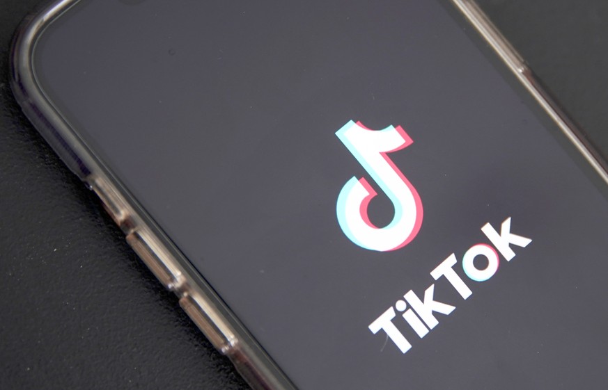 epa10635395 In this photo illustration the TikTok logo is displayed on a phone in Los Angeles, California, USA, 17 May 2023. Govenor Greg Gianforte of Montana signed a measure that bans the TikTok app ...