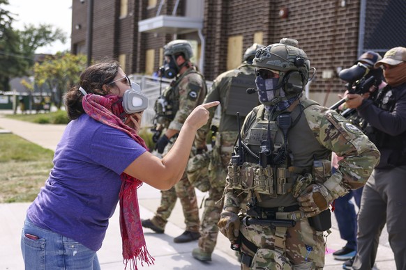 A protester confronts an Immigration and Customs Enforcement officer outside of an ICE facility in Broadview, Friday, Sept. 19, 2025. (Anthony Vazquez/Chicago Sun-Times via AP)
Trump Immigration Chica ...