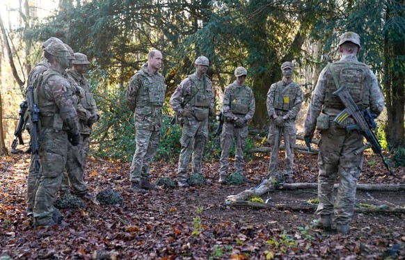 SALISBURY, ENGLAND - NOVEMBER 23: Prince William, Prince of Wales, Colonel-in-Chief, 1st Battalion Mercian Regiment (L) listens to a briefing ahead of an attack exercise during a visit to the regiment ...