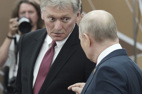 Russian President Vladimir Putin, right, talks to Kremlin spokesman Dmitry Peskov on the sidelines of the Russia-Africa Summit and Economic and Humanitarian Forum in St. Petersburg, Russia, Thursday,  ...