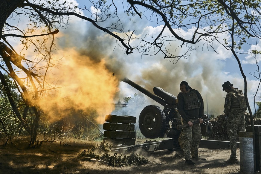Ukrainian soldiers fire a cannon near Bakhmut, an eastern city where fierce battles against Russian forces have been taking place, in the Donetsk region, Ukraine, Friday, May 12, 2023. (AP Photo/Libko ...
