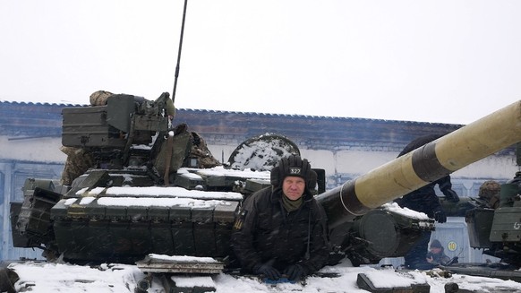 Kharkiv, Ukraine - January, 31, 2022: The tanker looks out of the hatch of the tank. The Ukrainian army is preparing for the invasion of Russian troops