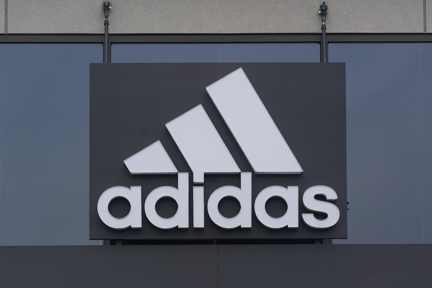 FILE - A sign is displayed in front of an Adidas retail store in Paramus, N.J., Oct. 25, 2022. Adidas is facing a class-action lawsuit from investors that was filed Friday, April 28, 2023, alleging th ...