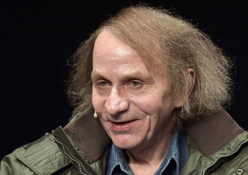 French novelist and poet Michel Houellebecq smiles towards the audience prior to a reading of his latest book in Cologne, Germany, Monday, Jan. 19, 2015. The controversial author appears in public for ...