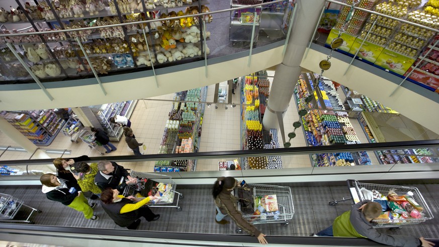 Customers ride up the man conveyors with their caddies at a store of supermarket chain &amp;quot;Migros&amp;quot; at the Glattzentrum shopping mall in Wallisellen in the canton of Zurich, Switzerland, ...