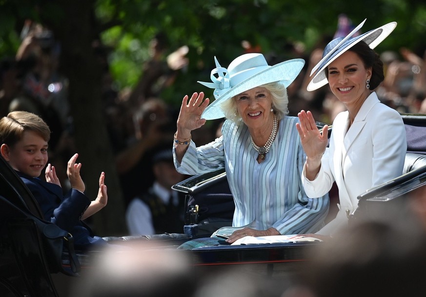 Britain&#039;s Camilla, Duchess of Cornwall, left, and Britain&#039;s Kate, Duchess of Cambridge, travel in a horse-drawn carriage.