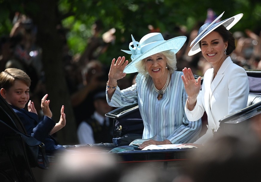 Britain's Camilla, Duchess of Cornwall, left, and Britain's Kate, Duchess of Cambridge, travel in a horse-drawn carriage.