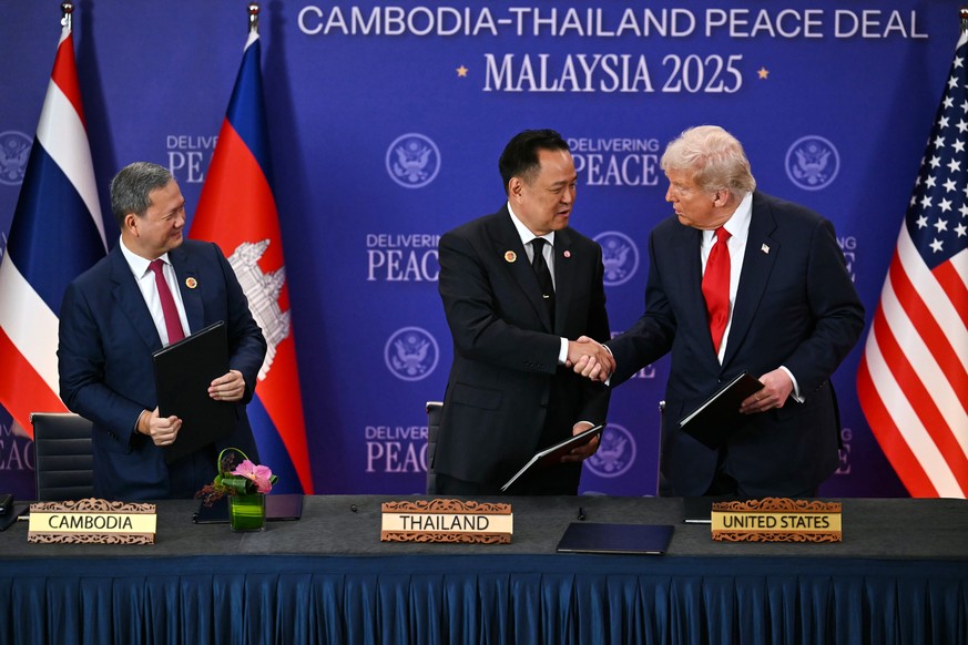 Cambodia&#039;s Prime Minister Hun Manet, left, watches Thailand&#039;s Prime Minister Anutin Charnvirakul and U.S. President Donald Trump shake hands on the sidelines of the 47th Association of South ...