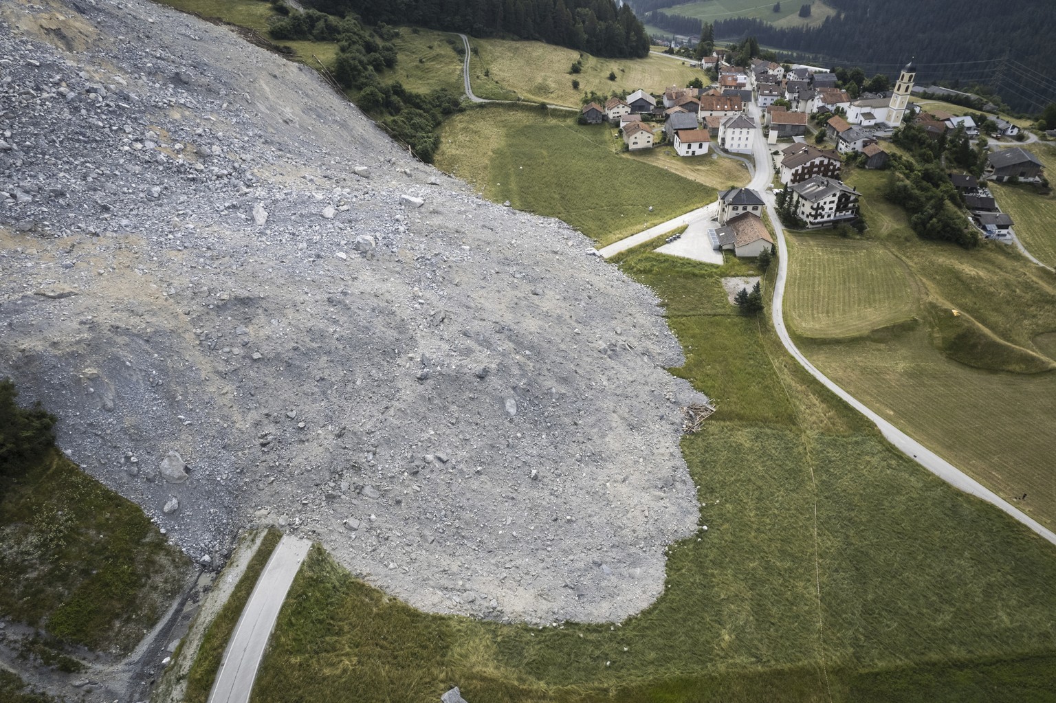 The rocks of a rockslide are seen in Brienz, Switzerland, Tuesday, July 4, 2023. Brienz was evacuated on May 12 after geology experts warned that Alpine rock looming over the village could break loose ...
