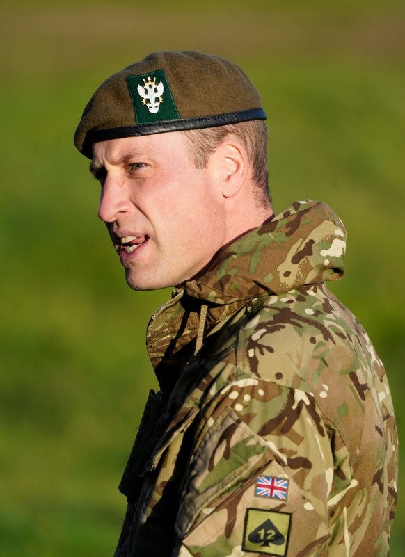 SALISBURY, ENGLAND - NOVEMBER 23: Prince William, Prince of Wales, Colonel-in-Chief, 1st Battalion Mercian Regiment (L) listens to a briefing ahead of an attack exercise during a visit to the regiment ...