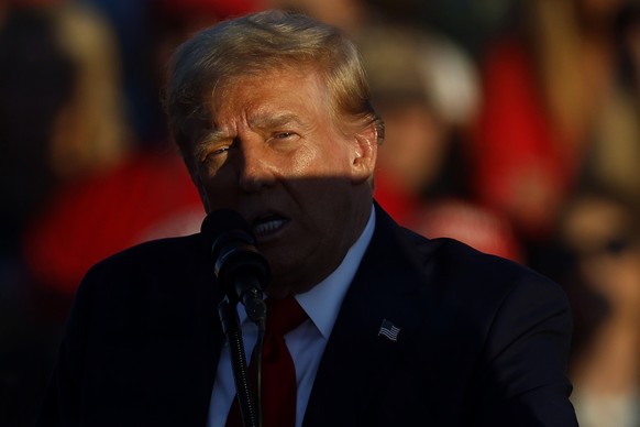BUTLER, PENNSYLVANIA - OCTOBER 05: A shadow is cast across Republican presidential nominee, former President Donald Trump as he addresses a campaign rally at the Butler Farm Show grounds on October 05 ...
