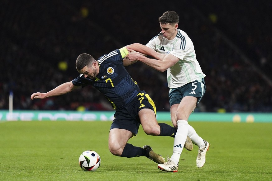 Scotland&#039;s John McGinn, left, and Northern Ireland&#039;s Eoin Toal battle for the ball during an international friendly soccer match between Scotland and Northern Ireland at Hampden Park, Glasgo ...