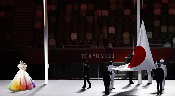 epa09359511 Japanese singer Misia sings the national anthem as the Japanese flag is being hoisted..during the Opening Ceremony of the Tokyo 2020 Olympic Games at the Olympic Stadium in Tokyo, Japan, 2 ...