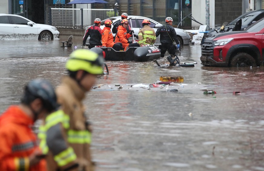 Rescue members search with a rubber boat on a street flooded by torrential rains in Daegu on July 17, 2025. At least three people were killed and more than 1,000 evacuated on July 17, after South Kore ...