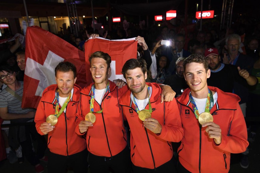 From right, Lucas Tramer, Mario Gyr, Simon Schuerch, Simon Niepmann of Switzerland celebrate their gold medal with fans after winning in the Lightweight-Four during a medal celebration in the House of ...