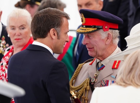 King Charles III greets French President Emmanuel Macron ahead of the UK national commemorative event for the 80th anniversary of D-Day, held at the British Normandy Memorial in Ver-sur-Mer, Normandy, ...