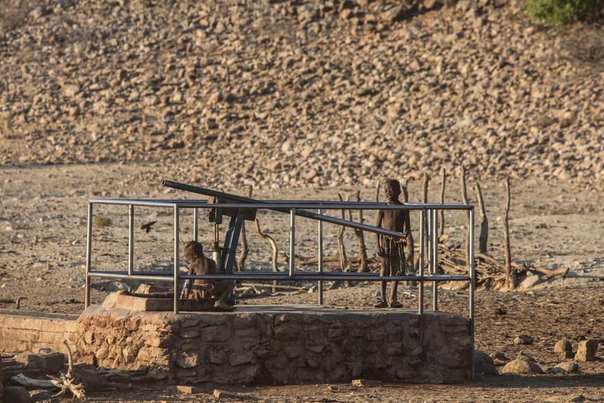 In this photo taken Monday, July 29, 2013. and supplied by UNICEF, children at a water pump in the Okangwati village, Kunene Province, northern Nambia. Children are the ones who suffer mostly from the ...