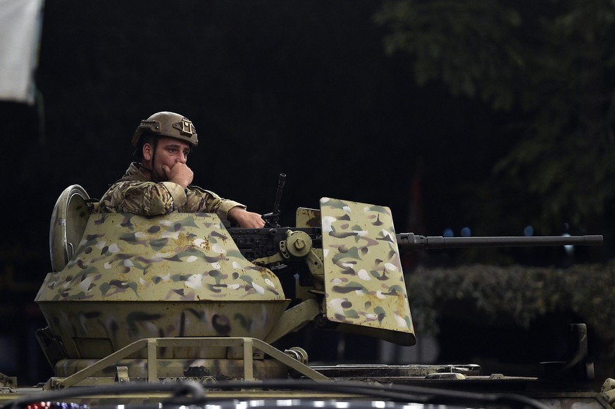 epa11621336 A Lebanese soldier secures the area in the southern suburb of Beirut after an Israeli military strike, in Beirut, Lebanon, 23 September 2024. The Israeli Defense Forces (IDF) said they con ...
